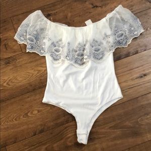 Off the shoulder body suit.